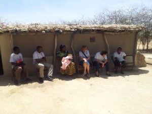 DTHD Board Member and volunteer Nancy Combronne, center, joins DCMC's Community Health Dept. for a post-natal visit to a new mother in rural Dodoma.